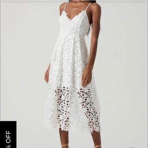 Tea length white lace dress with sheer overlay and spaghetti straps